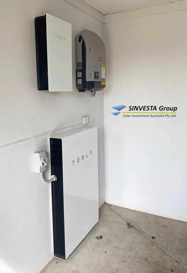 A Tesla Powerwall installed on a garage wall by Sinvesta.
