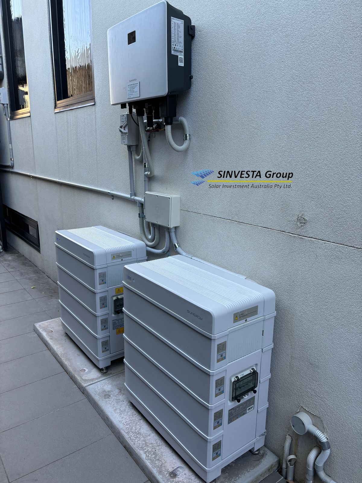 Two Fronius Symo Advanced inverters mounted side by side.