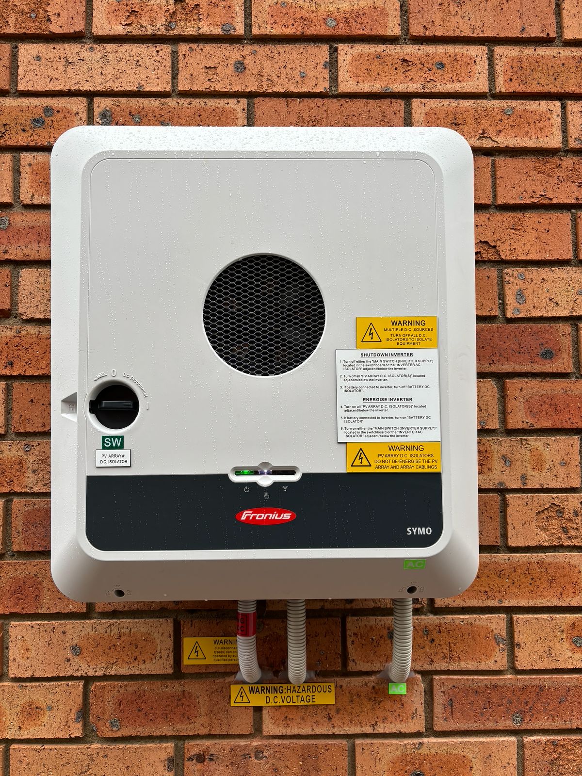 Fronius Symo inverter installed with conduit.