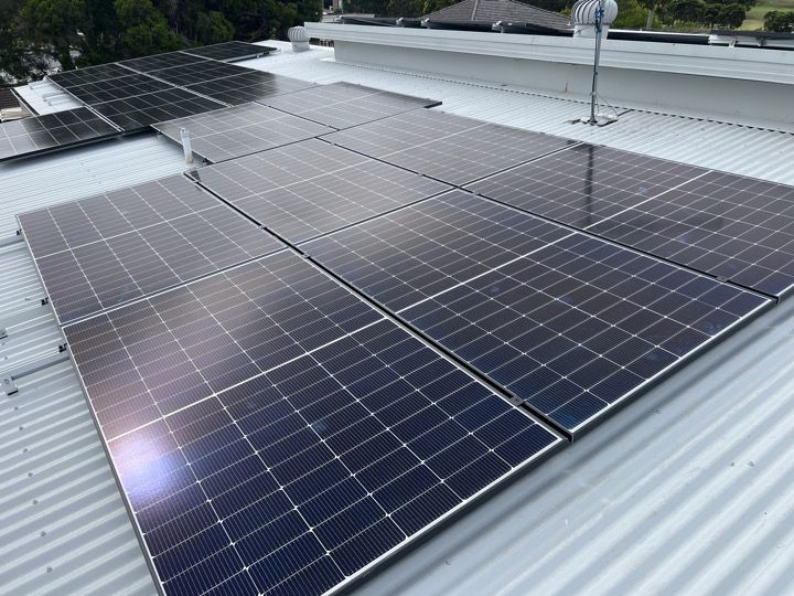 Commercial solar array on a metal warehouse roof.